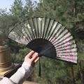 Traditional Chinese folding fan in dark green with pink floral pattern and black tassel - Dark Green Butterfly & Floral Style (Fan 78)