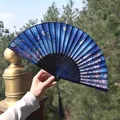 Deep blue folding fan featuring cherry blossom and butterfly patterns with silk tassel - Dark Blue Cherry Blossom Butterfly Style (Smiling Fan 62)