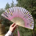 Pink gradient floral folding fan with bamboo ribs and silk tassel in hand - Pink-White Gradient Flower & Butterfly Style (Smile Fan 61)