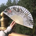 Traditional Chinese folding fan with Jiangnan scenery painting and yellow tassel detail - Water Town Color Ink Style (Smile Fan 52)
