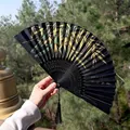 Classic Chinese folding fan in black silk with green bamboo print and long black tassel - Black with Gold & Green Bamboo Pattern (Fan Style 88)