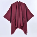 Detailed close-up of dark wine red knitted poncho with tassel edges and large front pockets - Pocket Style Wine Red