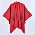 Elegant red knit poncho featuring fringe tassels and side pockets for casual winter wear - Pocket Style Red