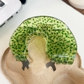 Translucent green acetate hair claw clip with dark floral patterns in a semi-round U-shape - 9cm / Speckled Green