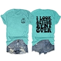 Detailed view of the mint green graphic tee and distressed denim shorts street style outfit - Deep Water Blue (Black Print)