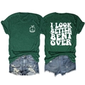 Flat lay of a green crew neck T-shirt with white back print and distressed denim shorts - Vintage Green (White Print)
