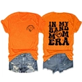 Détails de l'imprimé graphique In My Band Mom Era sur le devant et l'arrière du t-shirt orange - Orange (Imprimé Noir)