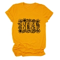 Close-up of BCBA floral print on a ginger yellow cotton t-shirt with crew neck design - Mustard Yellow (Black Text)