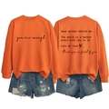Detailed view of an orange crewneck sweatshirt featuring you are enough back print and denim shorts - S / Orange (Black Font)
