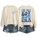 Detail view of Boy Mom Era crewneck sweatshirt with blue back print and denim shorts - Sand