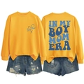 Flat lay of yellow long sleeve sweatshirt with In My Boy Mom Era print and denim shorts - Yellow