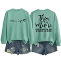 Detail of mint green sweatshirt with Mimi Life print and distressed denim shorts - Light Green (Black Print)