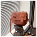 Detail of caramel faux leather saddle bag with double vertical straps and resin hardware - Brown