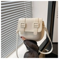 Detail of white vintage saddle bag featuring a dual square buckle and leather strap - White