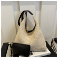 Detail of woven straw tote bag with black leather straps and matching inner pouch - Beige Bag With Black Strap Set / Black