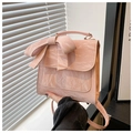 Detail of pink bow backpack with marble texture showing handle and flap closure - Pink