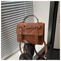 Detailed close-up of brown vintage PU leather bag with heart emboss and bow decoration - Brown