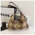 Detail of vintage plaid tweed hobo bag with gold logo plate and leather strap - Brown
