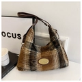 Close-up of brown plaid plush tote bag featuring soft faux fur texture and leather strap - Brown