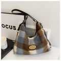 Detailed view of plaid plush tote bag with gold chain and leather shoulder strap - Blue