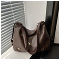 Detailed texture of dark coffee PU leather tote bag with golden butterfly accents - Coffee