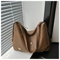 Detailed view of brown PU leather bag with butterfly metal hardware and zipper details - Brown