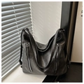 Detail of matte black PU leather hobo bag with dual vertical zippers and natural shadows - Black
