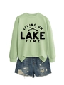 Detail view of light green crewneck sweatshirt with Lake Time text and blue denim shorts - Olive Green Sweatshirt (Black Font)