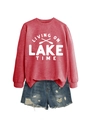 Detail of red crewneck sweatshirt featuring Living on Lake Time print and frayed denim shorts - Red Sweatshirt (White Font)