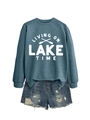 Flat lay of foggy blue sweatshirt with Living on Lake Time print and denim shorts - Blue Sweatshirt (White Font)