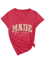 Close-up of floral print text and stylish knotted hem on a V-neck red cotton T-shirt - S / Red
