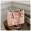 Detailed texture of pink pleated tote bag with silver butterfly and pearl chain charm - Pink