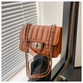 Detail of caramel quilted square bag with diamond twist lock and chain strap - Brown