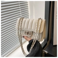 Detail of white quilted leather crossbody bag featuring silver turn-lock and chain strap - White