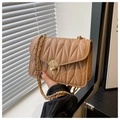 Detail of camel quilted crossbody bag featuring wave patterns and gold chain strap - Khaki