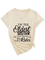 Detail of V-neck beige t-shirt with I'M THE Oldest SISTER printed slogan and stylish knot - S / Sand (Black Font)