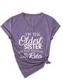 Detail of purple V-neck t-shirt featuring 'Oldest Sister' quote and side-knot hem design - Purple (White Font)