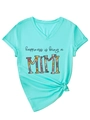 Detail of mint green V-neck T-shirt with flower MIMI print and stylish front hem knot - S / Deep Water Blue (Black Graphic) (3812)
