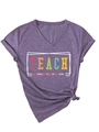 Detail of V-neck purple t-shirt featuring colorful Teach Them To Be Kind print and knot hem - Purple (White Graphic)