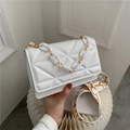 White geometric quilted crossbody bag with chunky chain handle and patterned strap - White