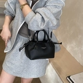 Black pebbled leather handbag for women featuring gold lettering and dual-use shoulder strap - Black