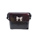 Close-up of the silver metal bow buckle on the snake and crocodile leather crossbody bag - Burgundy Crocodile Pattern