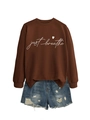 Detail of Just Breathe script and heart print on a brown crewneck sweatshirt fabric - Coffee (White Font)