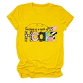 Flat lay of yellow t-shirt featuring 'Teaching is a work of HEART' text with textured patterns - Yellow (Black Text)