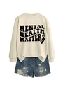 Detail of Mental Health Matters lettering on cream sweatshirt with distressed denim shorts - Sand (Black Font)