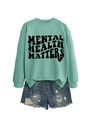 Close-up of Mental Health Matters text printed on mint green long sleeve sweatshirt - Light Green (Black Text)