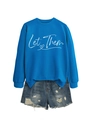Detail of blue Let Them sweatshirt and distressed denim shorts with frayed edges - Lake Blue (White Print)