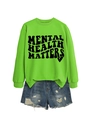 Flat lay of green Mental Health Matters sweatshirt with distressed denim shorts - Neon Green (Black Font)