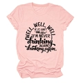Close-up of pink crew neck T-shirt featuring bold black Well well well typography - Pink (Black Print)