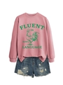 Détail d'un sweat rose à col rond avec motif coq vert et texte graphique moderne - Or rose